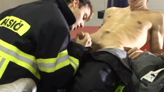 young fireman blows his buddy in the station house